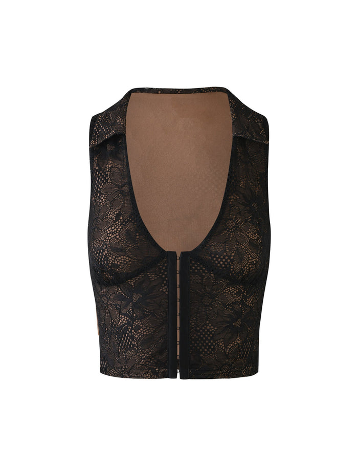 The ALDINA TOP - BLACK : LACE by TIGERMIST is a stylish and sleeveless black lace crop top featuring a plunging neckline. Its fabric boasts an intricate floral lace pattern, offering a semi-transparent look. Designed to fit snugly, this top ends slightly above the waist and has a similar design in the back.