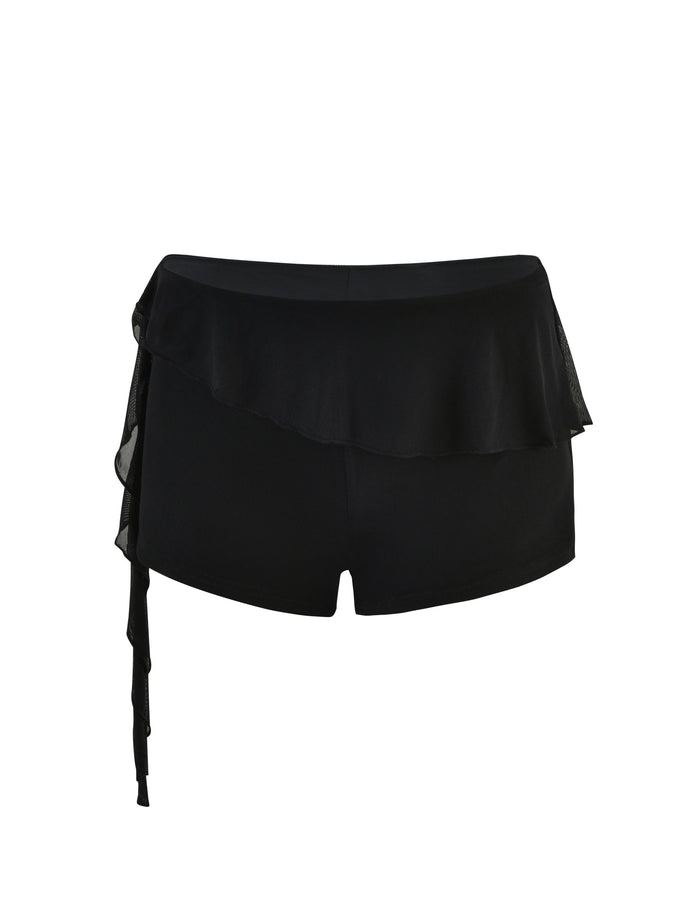 A pair of black ANISHA SHORTS by TIGERMIST, featuring a flowy, layered ruffle detail on the waistband and a tie feature on the left side. The shorts have a smooth texture and exhibit a modern, chic design.