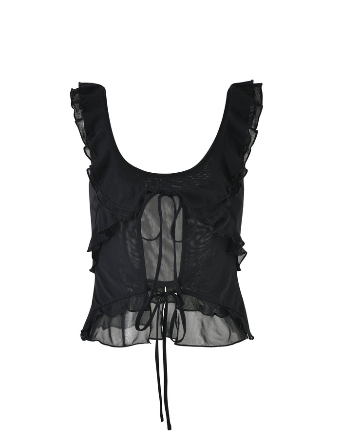 The ANISHA TOP - BLACK by TIGERMIST is a sleeveless crop top featuring a scoop neck with ruffled edges. The slightly sheer design includes a tie closure at the front and additional ruffles along the sides and hemline, creating a delicate, feminine look.