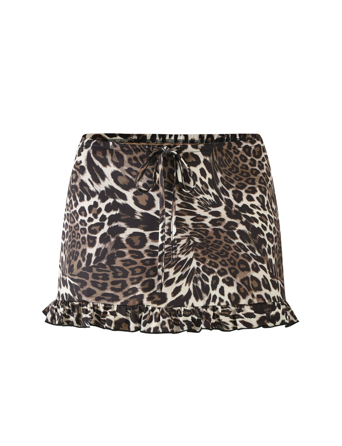 The APOLLO SKIRT - MULTI : LEOPARD from TIGERMIST is a short skirt with a leopard print pattern in shades of brown, black, and white. It features a drawstring tie at the waist and a ruffled hem at the bottom, adding a playful touch to its design. The skirt is displayed against a white background.