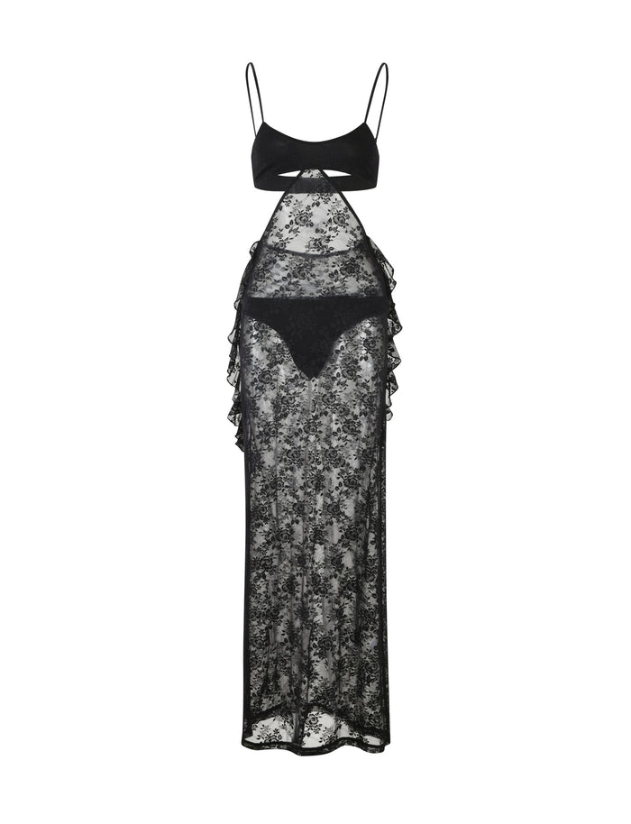 The TIGERMIST ARES MAXI DRESS - BLACK features thin shoulder straps and a cutout at the bust, accentuated with ruffled lace detailing on the sides. The sheer, floral-patterned lace overlays a bralette and high-waisted panties underneath.