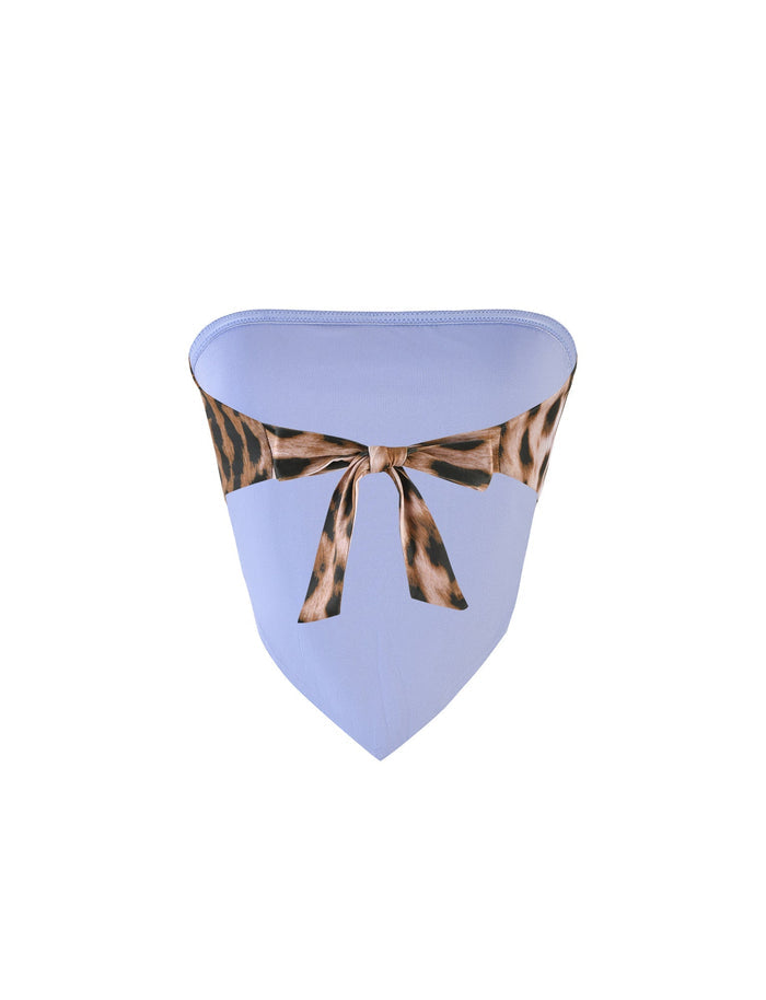 An image of the BRIXLEY TOP - MULTI : LEOPARD from TIGERMIST, featuring a light blue, triangular bikini bottom with a leopard print waistband and a tied bow at the front. The smooth fabric and stylish design make it trendy and fashionable.