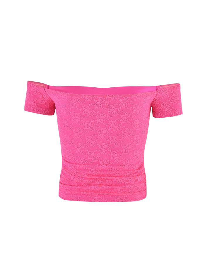 The CAIDEN TOP by TIGERMIST is a vibrant hot pink off-the-shoulder crop top, featuring a subtle floral lace pattern. The top has short sleeves and a snug fit, highlighting its intricate texture and design.