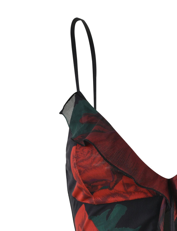 Close-up of the TIGERMIST CARLY DRESS - BLACK : MACRO ROSE- RED ROSE featuring large red rose print details. The dress has thin adjustable straps and a ruffled neckline, with fabric that appears to be lightweight and smooth.