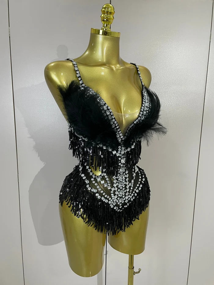 Claire rhinestone feather tassel mesh bodysuit for women. Sexy performance outfit for nightlife, dance, and stage events.