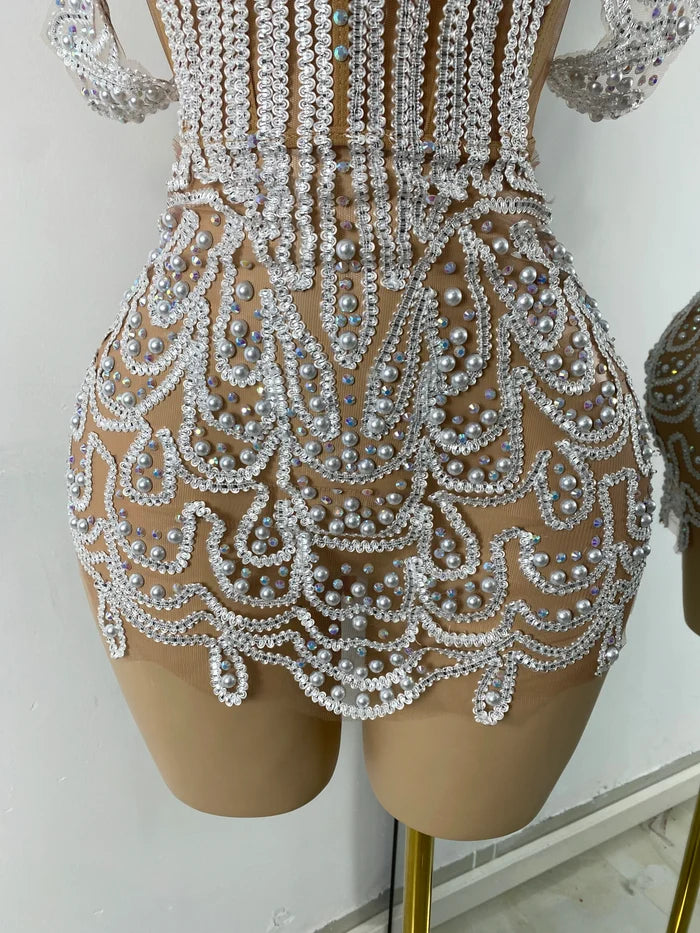 Shine in the Claren pearl and rhinestone off-the-shoulder mesh bodycon mini dress. Perfect for birthdays, parties, and special occasions.