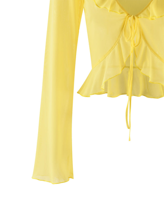 The CORVIN TOP - YELLOW: LEMON by TIGERMIST is a long-sleeve blouse featuring a drawstring tie at the front. It boasts a ruffled V-neckline and hem, with lightweight and slightly sheer fabric enhancing its delicate charm.
