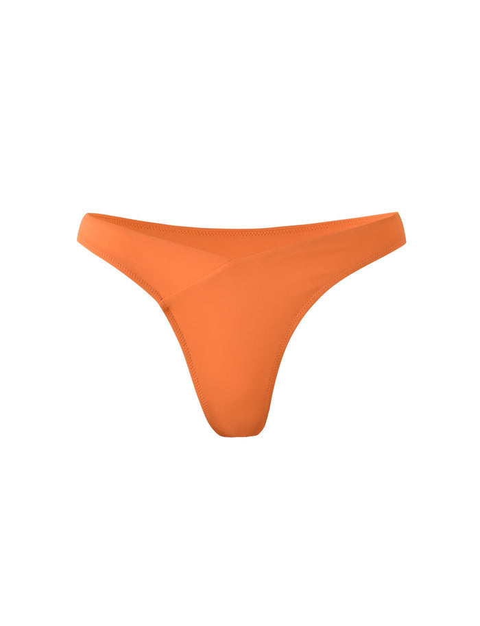 The CYNTHIA V CUT BIKINI BOTTOM - ORANGE : BURNT ORANGE by TIGERMIST is displayed against a white background. The design is simple, featuring a low-rise waist with a smooth, sleek finish.