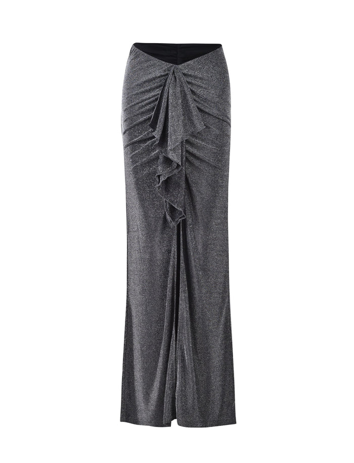 The DAISIE SKIRT by TIGERMIST is a high-waisted black shimmer skirt that features a ruffled design down the center front, adding texture and elegance. It flares slightly at the hem, creating a sophisticated silhouette with its soft and flowy fabric.