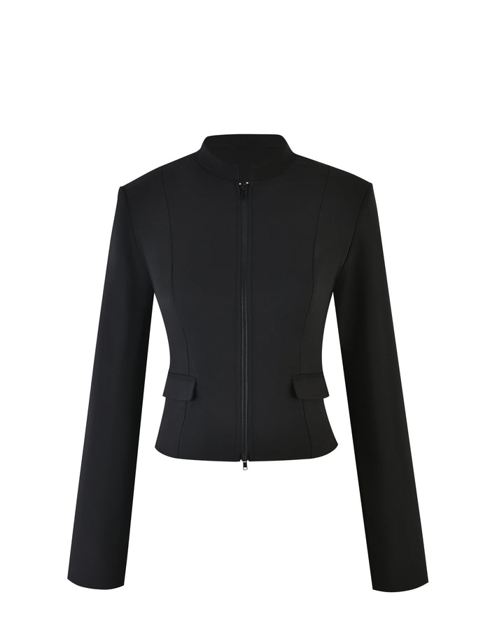 The DAMIRA JACKET - BLACK from TIGERMIST is a sleek, collarless women's blazer featuring a front zipper closure, long sleeves, and two small flap pockets on either side of the waist.