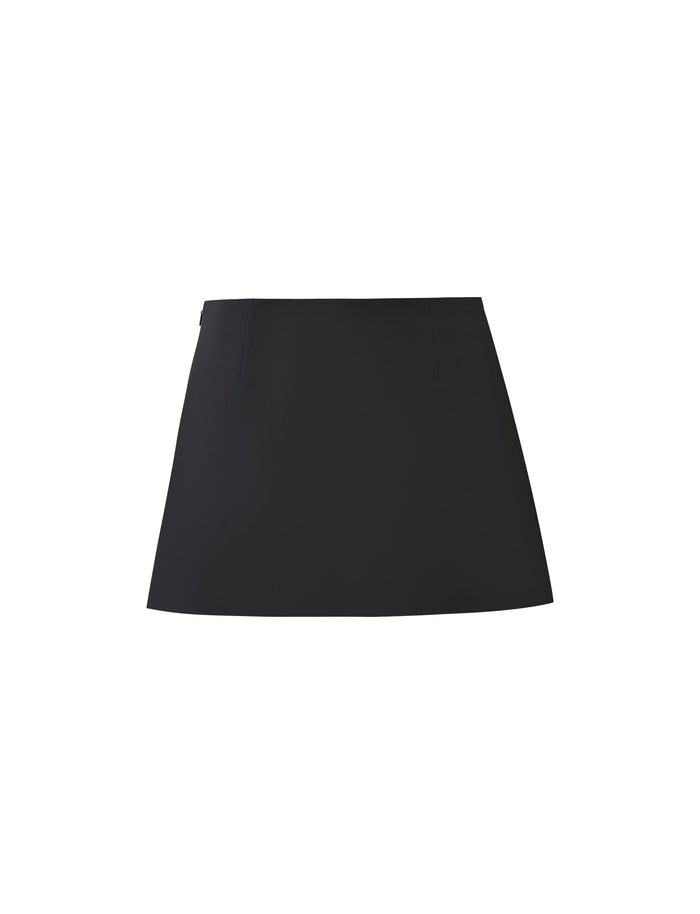 A white background showcases the DAMIRA SKORT - BLACK from TIGERMIST, a black, high-waisted, A-line mini skirt with a simple design. The skirt features a clean and smooth surface and appears to be made of structured fabric.