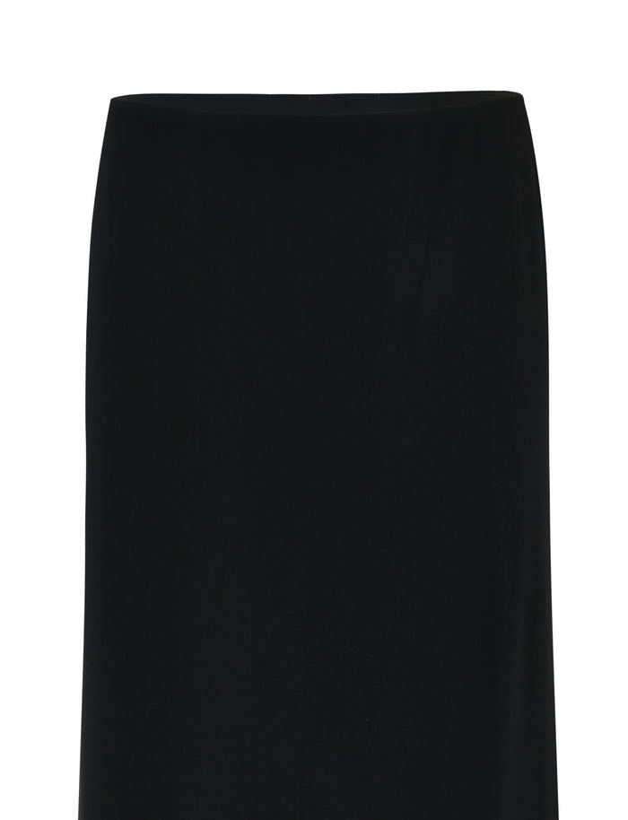 A sleek, knee-length skirt named the Deanna Maxi Skirt - Black from TIGERMIST is showcased against a plain white background. This sophisticated piece features a straight, minimalist design devoid of any embellishments or patterns. Made from smooth fabric, it exudes an elegant and refined aesthetic.
