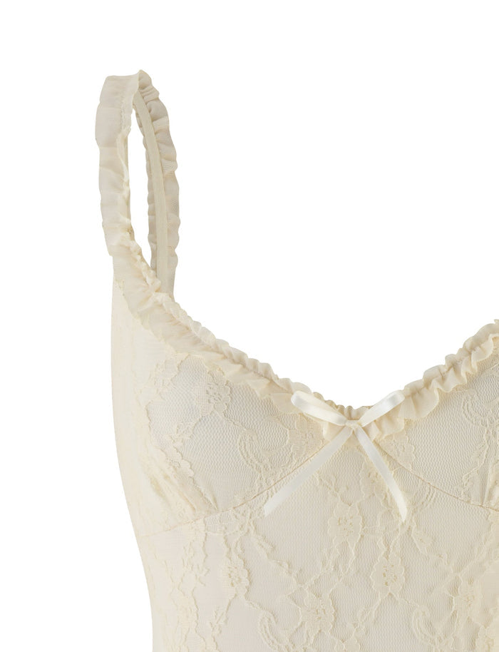 Close-up of the TIGERMIST DEJA BODYSUIT in beige champagne, featuring delicate floral champagne lace, ruffled straps, and a small bow at the center of the sweetheart neckline.