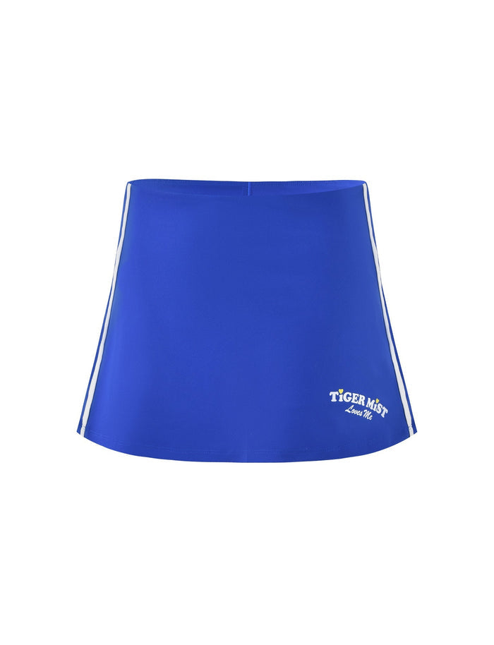 Introducing the DELANEY SKORT - BLUE by TIGERMIST: a royal blue mini skort adorned with white side stripes and featuring the phrase "Tiger Mist since 2007" in white text on the lower right corner. This skort showcases a simple yet sporty design.