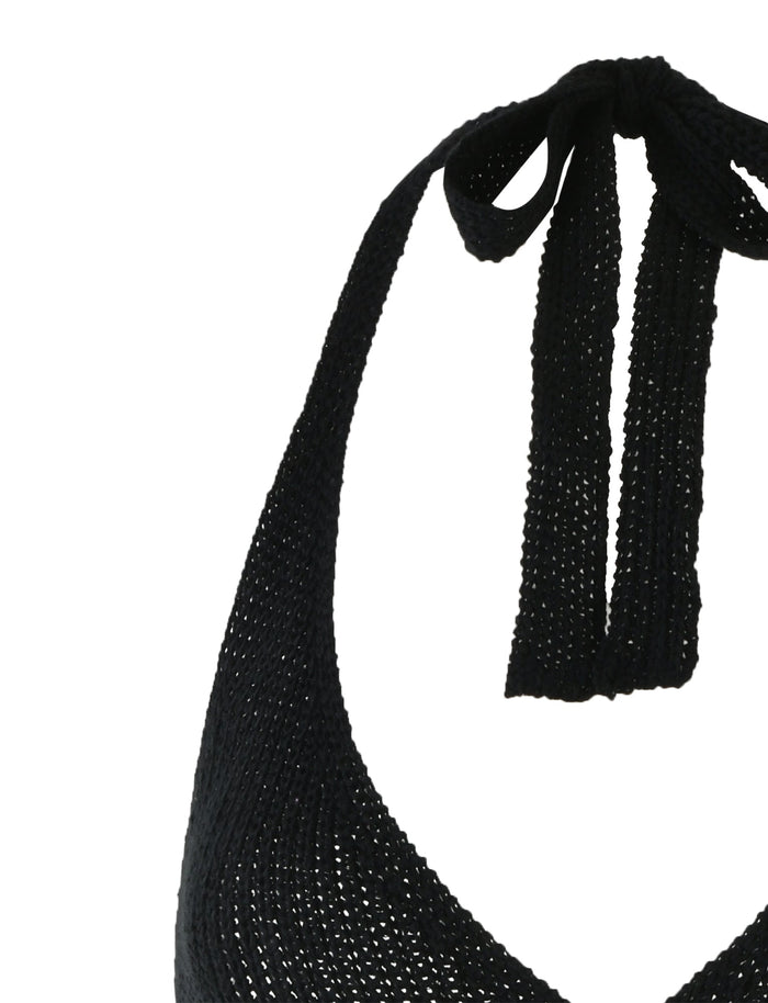 A black Delta Mini Dress from TIGERMIST featuring a textured knit design. The dress has a tied bow at the back of the neck, adding a stylish touch. The knit pattern gives the fabric a slightly raised, woven appearance. The upper part of the dress is visible in the image.