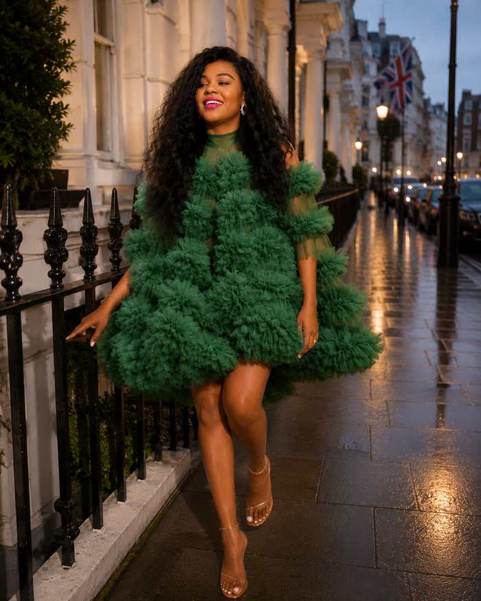 Woman wearing emerald green floral tulle mini dress walking on a luxury city street