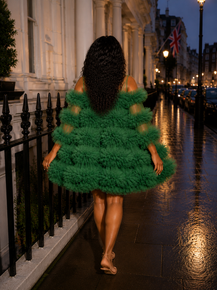 Stylish woman in luxury floral mini dress outdoors at night