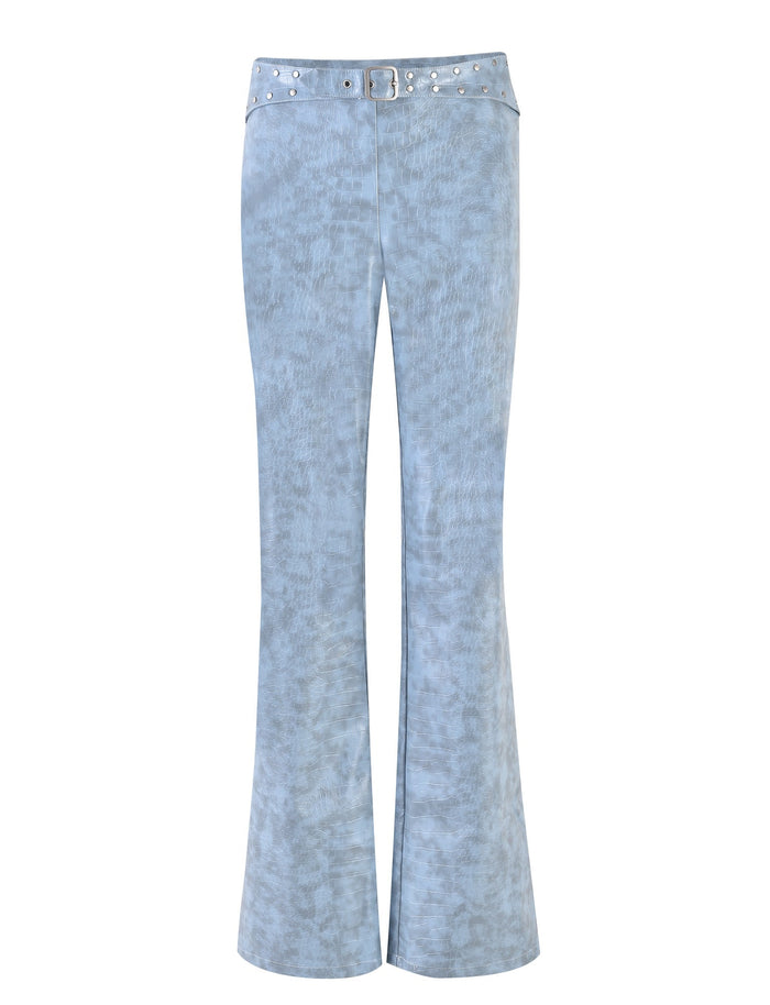 A pair of dusty blue EMERSYN PANTs by TIGERMIST with a textured fabric pattern. These high-waisted jeans come with a matching belt adorned with metallic studs and a buckle.