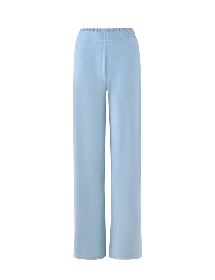 Baby blue, high-waisted wide-leg pants with an elastic waistband by TIGERMIST. The fabric is smooth and has a minimalistic, streamlined design without any visible embellishments or pockets. These pants are named the ERICKA PANT - BLUE.
