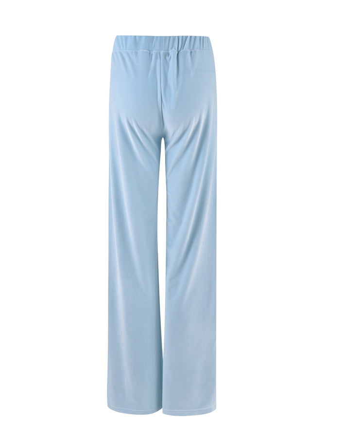 A pair of ERICKA PANT - BLUE : BABY BLUE lounge pants from TIGERMIST, featuring a light blue color and an elastic waistband. These straight-legged pants have a relaxed fit and are made from soft, smooth fabric. The back view of the pants is displayed against a white background.