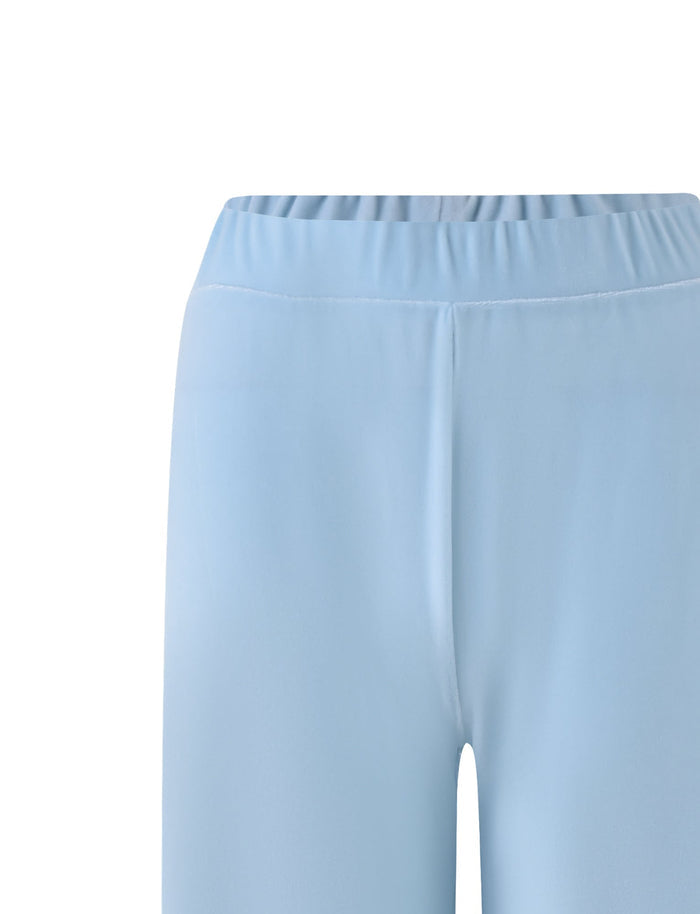 A close-up view of the waistband and upper thighs of the ERICKA PANT - BLUE : BABY BLUE from TIGERMIST. These light blue pants feature an elastic waistband and a smooth texture, set against a plain white background.