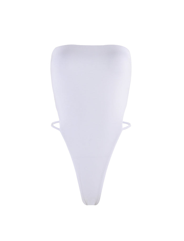 The FINIAN BODYSUIT - WHITE from TIGERMIST is a white, strapless bodysuit with a high-cut leg design. This minimalist piece features smooth fabric for a sleek and seamless look, while two thin side strings provide added support and structure.