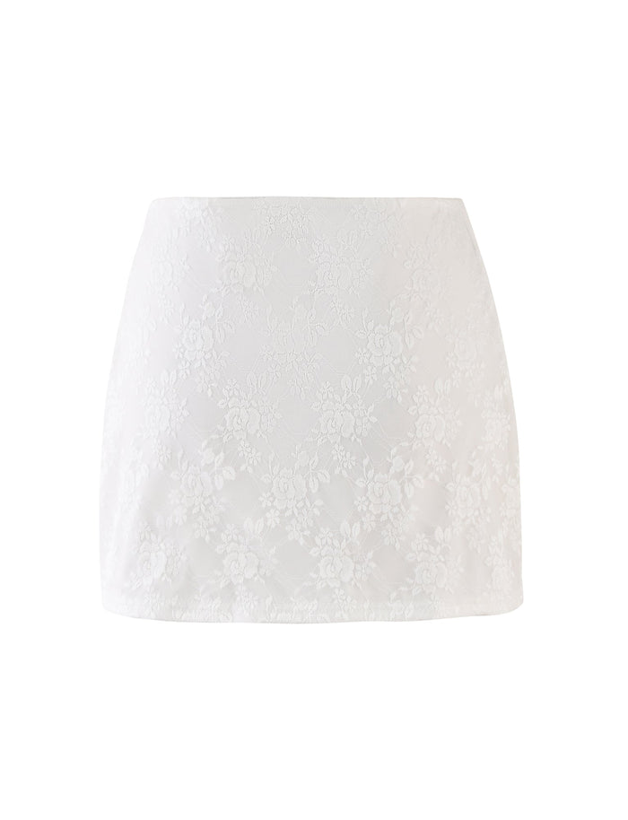 The Florian Skirt by Tigermist in white features a high-waisted, A-line silhouette embellished with a subtle floral lace pattern. Made from lightweight, semi-sheer fabric, this mini skirt combines simple elegance with delicate floral design.