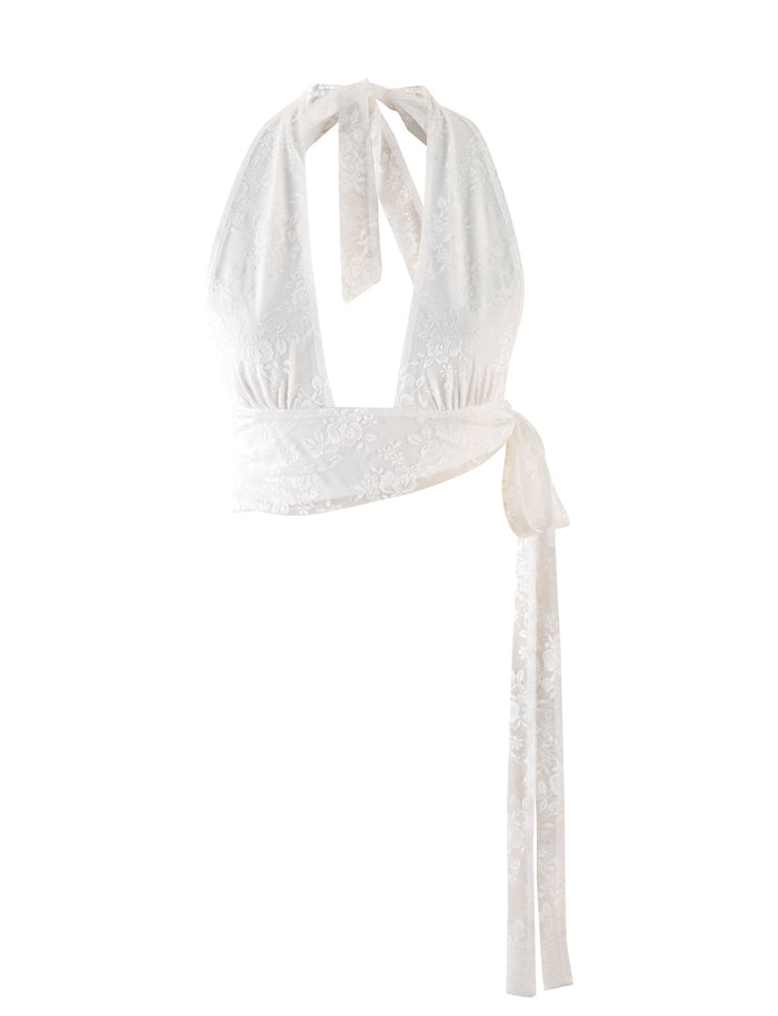 The FLORIAN TOP - WHITE : LACE by TIGERMIST features a white lace halter design with a keyhole neckline and tied straps at the back. This elegant top also includes a long sash that wraps around the waist for a fitted look, and is crafted from high-stretch lace fabric with delicate floral patterns in a crop length.