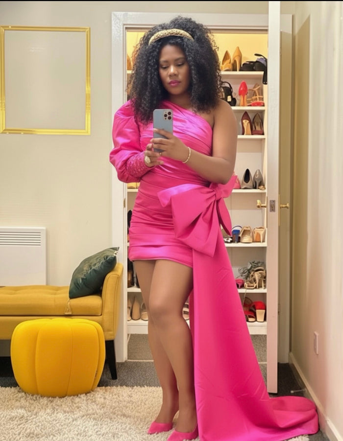 Woman in a pink dress taking a mirror selfie