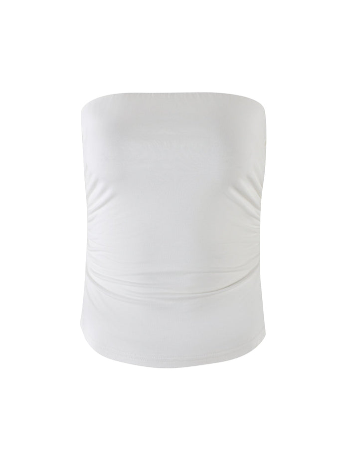 The HARRIETT JERSEY TUBE TOP - WHITE by TIGERMIST is a white tube top made from stretchy fabric. This simple, strapless design features subtle side ruching for a flattering fit and has a plain, smooth texture, making it suitable for both casual and semi-formal wear.