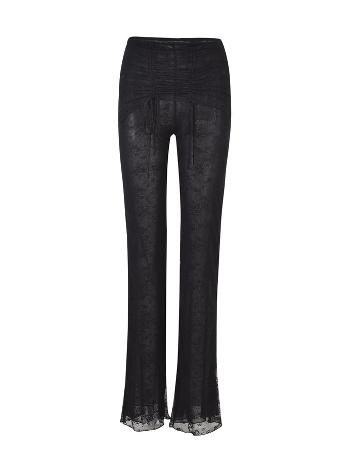Introducing the INAYAH PANT - BLACK by TIGERMIST: These high-waisted black lace pants feature elegant tie strings at the front. Crafted from a sheer fabric for a semi-transparent look, they boast a loose, flowy fit through the legs.