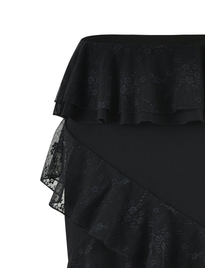 A close-up image of the TigerMist INAYAH SKIRT - BLACK, featuring tiered, ruffled lace details. The fabric has a delicate floral pattern, adding elegance and texture to the overall design.