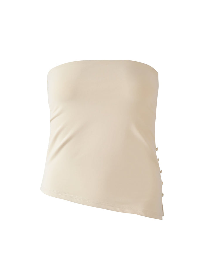 The TIGERMIST INDIRA TOP in cream is a strapless, fitted top with small side buttons and an asymmetrical hem, shown against a plain white background.