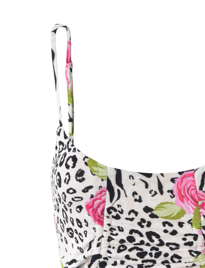 Close-up of the TIGERMIST IRIE TOP in a multi-pattern design featuring a mix of black leopard spots, zebra stripes, large pink roses, and green leaves on a white base. The top has a fitted bodice with thin shoulder straps.
