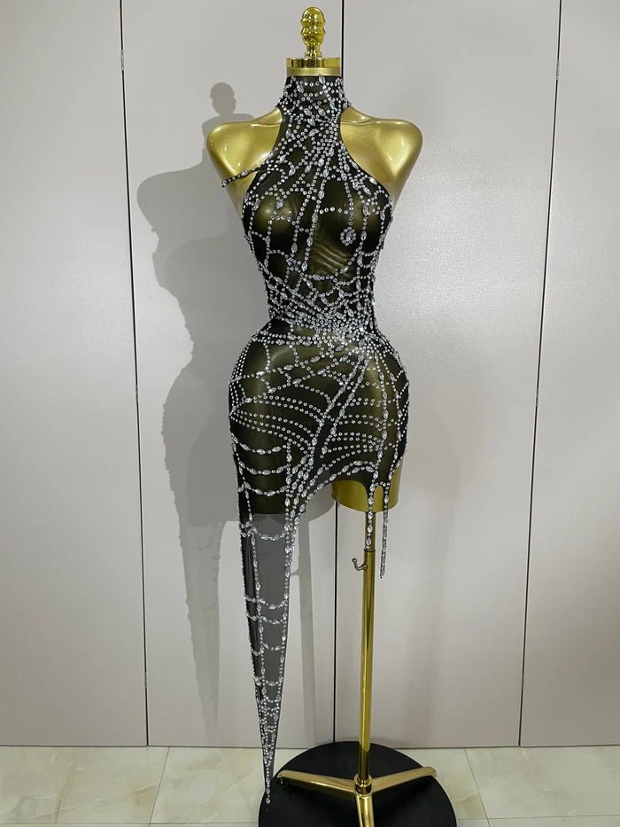 Sparkle in the Jaila rhinestone mesh asymmetric bodycon mini dress. Sexy party dress for birthdays, clubs, cocktail parties, and special events.