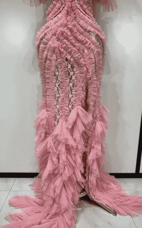 Elegant pink mesh evening gown with soft flowing fabric and feminine silhouette