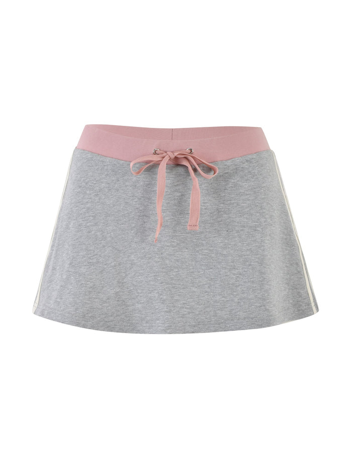 The JAYLEE SKORT - GREY from TIGERMIST features a stylish A-line design with a pink waistband and pink drawstring tie at the front. Suitable for various occasions, this casual yet fashionable skirt is crafted from fabric that appears soft and comfortable.
