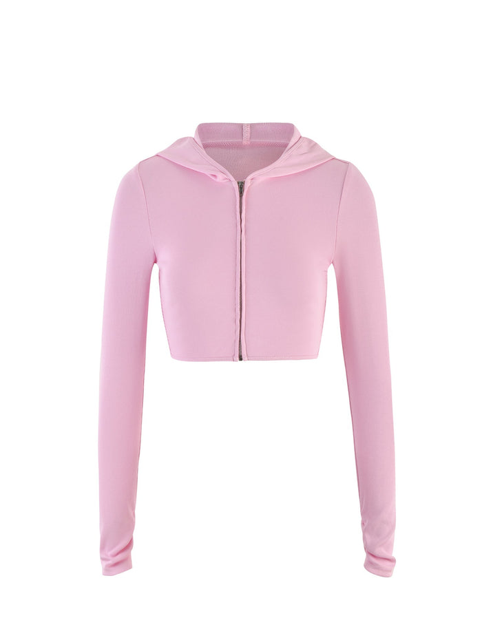 The KARINA JUMPER - PINK from TIGERMIST is displayed against a white background. This light pink cropped hoodie features long sleeves, a front zipper closure, and a fitted design that embodies a simple, casual style.