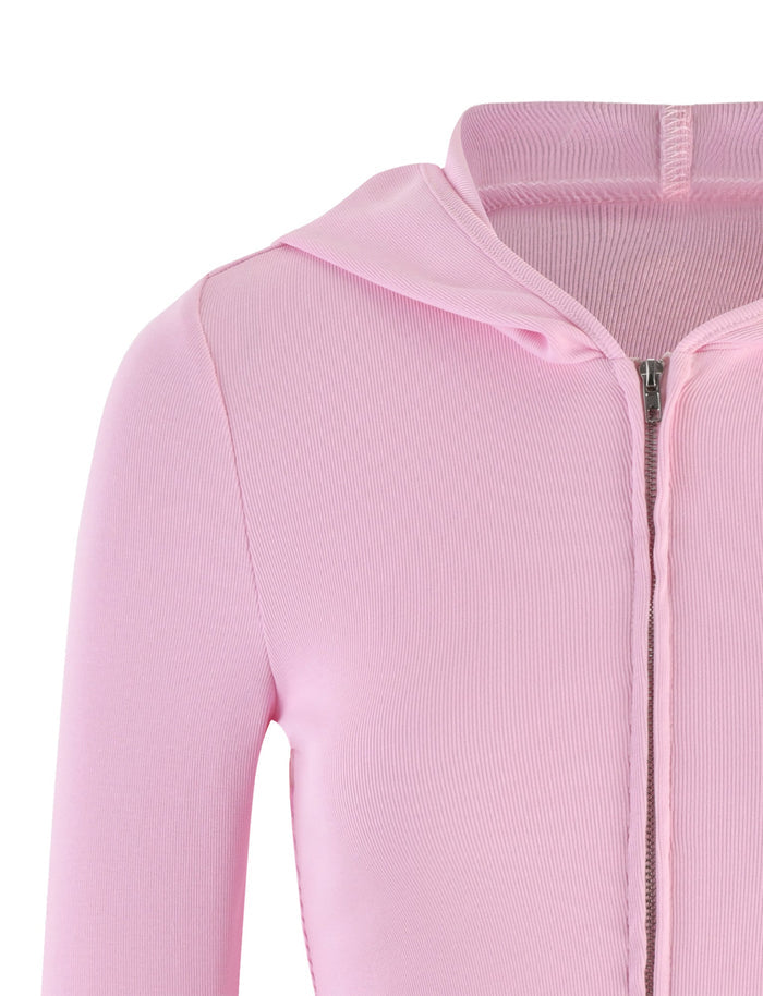 Close-up image of the KARINA JUMPER - PINK by TIGERMIST. The jumper features a ribbed texture and a visible zipper along the front. The fabric appears soft and smooth with a consistent light pink color, and the hood is slightly folded down. Only the upper portion is shown.