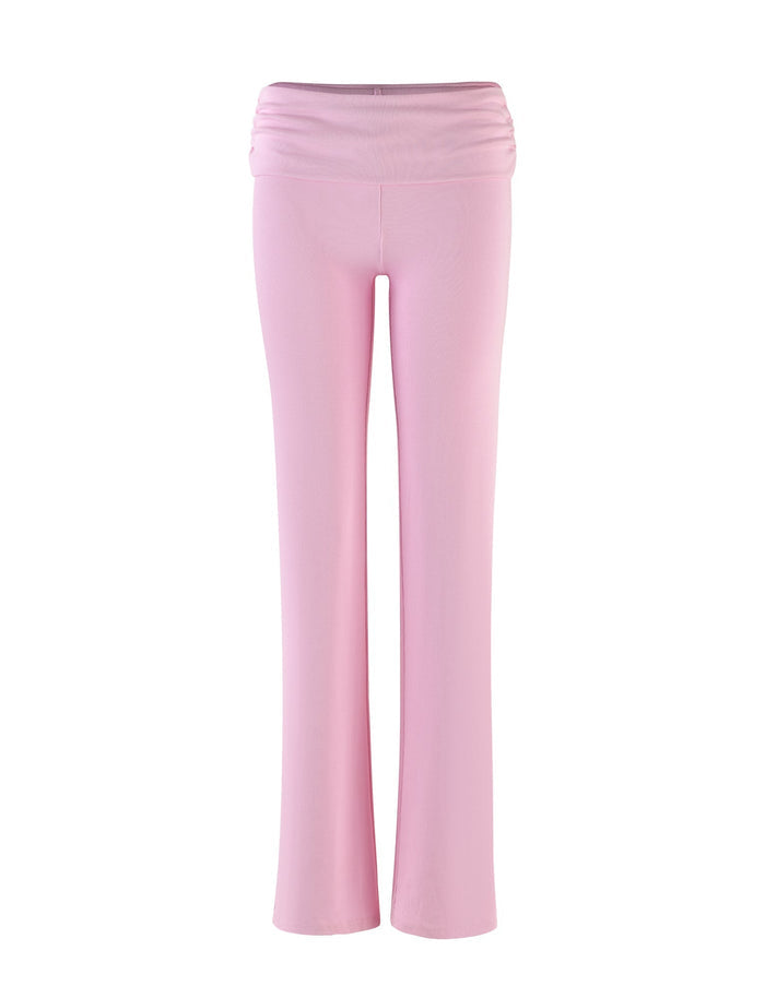 The KARINA PANT - PINK : BLUSH from TIGERMIST is displayed against a white background. These light pink, high-waisted, wide-leg pants feature a smooth, stretched waistband with gentle pleats just below it, offering both a flattering and comfortable fit.