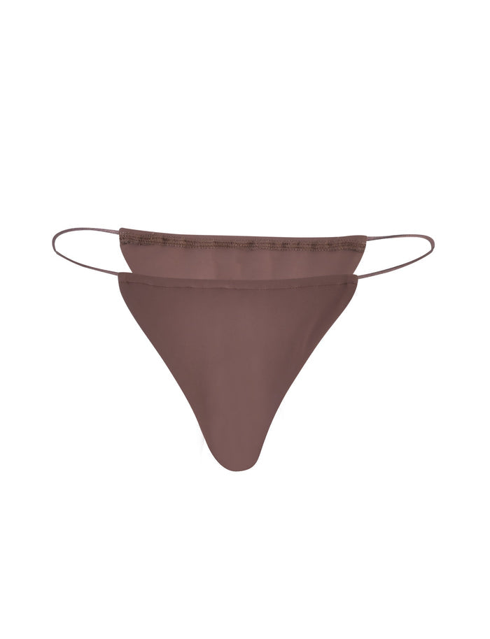 An image of the KRYZE BIKINI BOTTOM in Chocolate Brown from TIGERMIST, styled as a thong with thin elastic straps on both sides. This piece features a minimalist aesthetic with smooth, solid-colored fabric and a slight curve to cover the necessary areas.