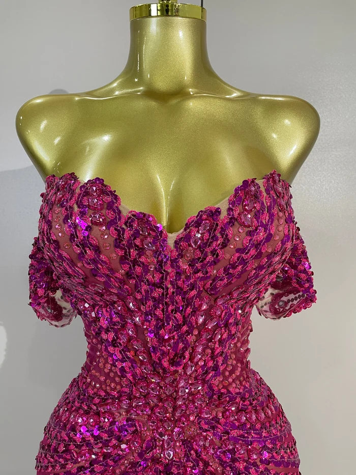 Turn heads in the Kyle rhinestone sequin off-the-shoulder mesh mini dress. Elegant party dress for birthdays, cocktail parties, and special events.