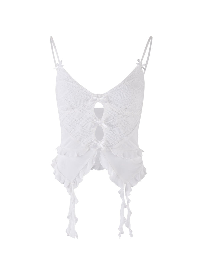 A TIGERMIST LAFAYETTE TOP - WHITE is displayed on a plain background. This elegant piece features thin spaghetti straps, intricate lace detailing with two small cutouts in the front, ruffled edge trim, and dangling ties at the bottom.