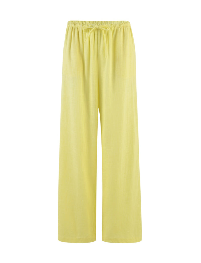 Introducing the LAINEY PANT - YELLOW : LEMON from TIGERMIST. These light yellow, wide-leg trousers feature an elastic waistband with a drawstring tie for adjustment. The material is lightweight and perfect for casual or comfortable wear.