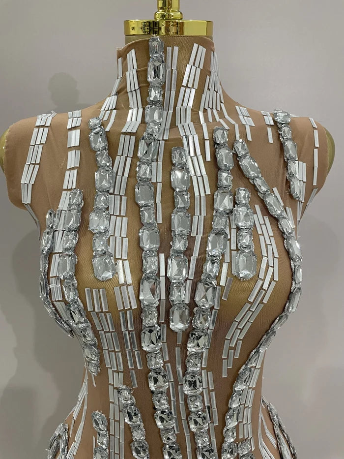 Shine in the Lani rhinestone chain transparent bodysuit. Sexy sleeveless mesh outfit for stage performances, parties, birthdays, and nightlife.