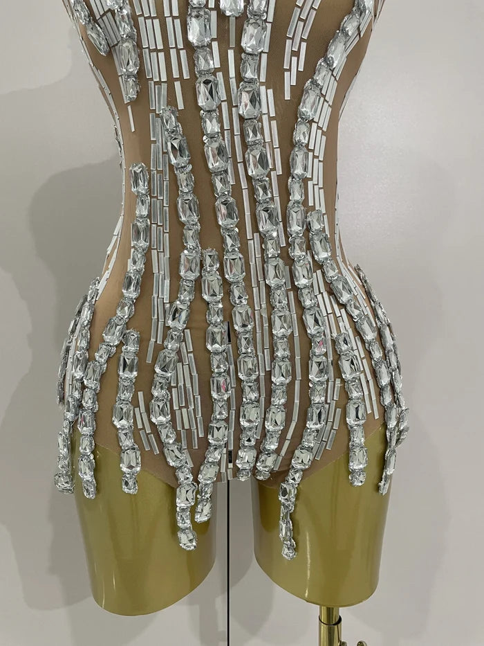 Shine in the Lani rhinestone chain transparent bodysuit. Sexy sleeveless mesh outfit for stage performances, parties, birthdays, and nightlife.