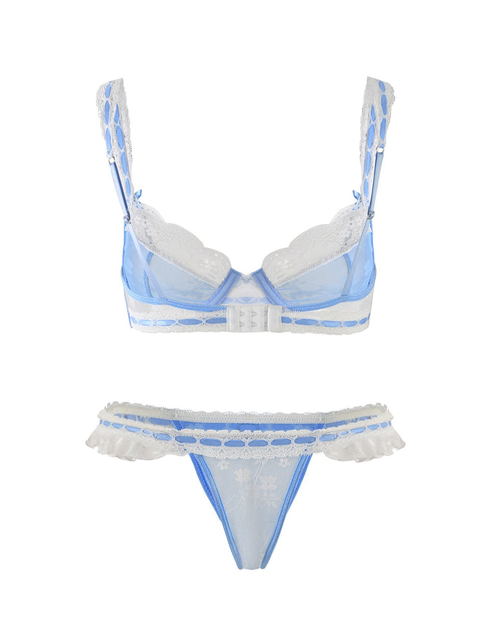 Check out the stunning TIGERMIST LAVINA SET in BABY BLUE, featuring a sheer baby blue bra with white lace trim, adjustable straps, and a hook closure at the back. The matching thong is adorned with a delicate lace pattern and frilled edges on either side.