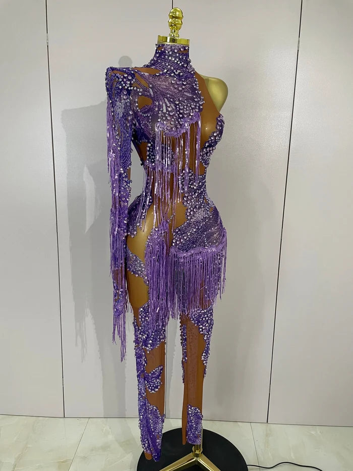 Leonna purple diamond tassel one shoulder mesh jumpsuit for women. Sparkly outfit for festivals, birthdays, nightlife, and stage wear.
