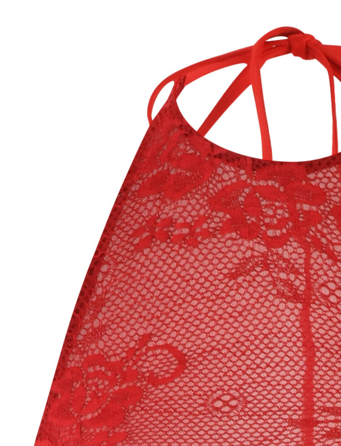 Close-up of the red lace fabric showcasing floral patterns from the TIGERMIST LUCIA DRESS - RED: LACE. The semi-transparent lace reveals a section of what appears to be this dress, featuring intricate detailing that complements its halter-style neckline and thin straps.