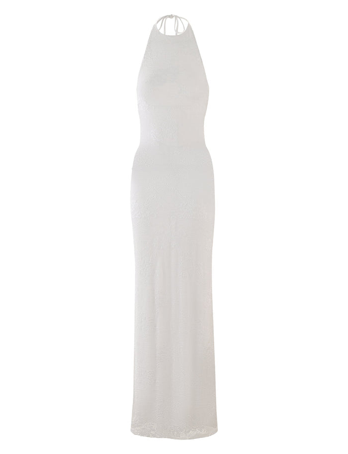 The LUCIA DRESS - WHITE : LACE from TIGERMIST is a sleeveless, floor-length dress with a halter neckline. It boasts an elegant, form-fitting design along with a subtle textured lace pattern throughout the fabric. The back features thin straps that tie at the neck for added sophistication.